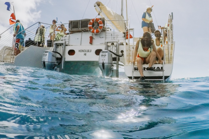 a group of people on a boat in the water
