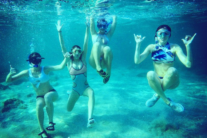 a group of people in a pool of water