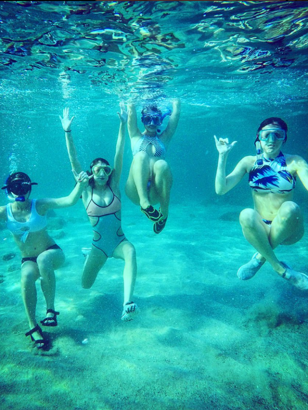 a group of people in a pool of water