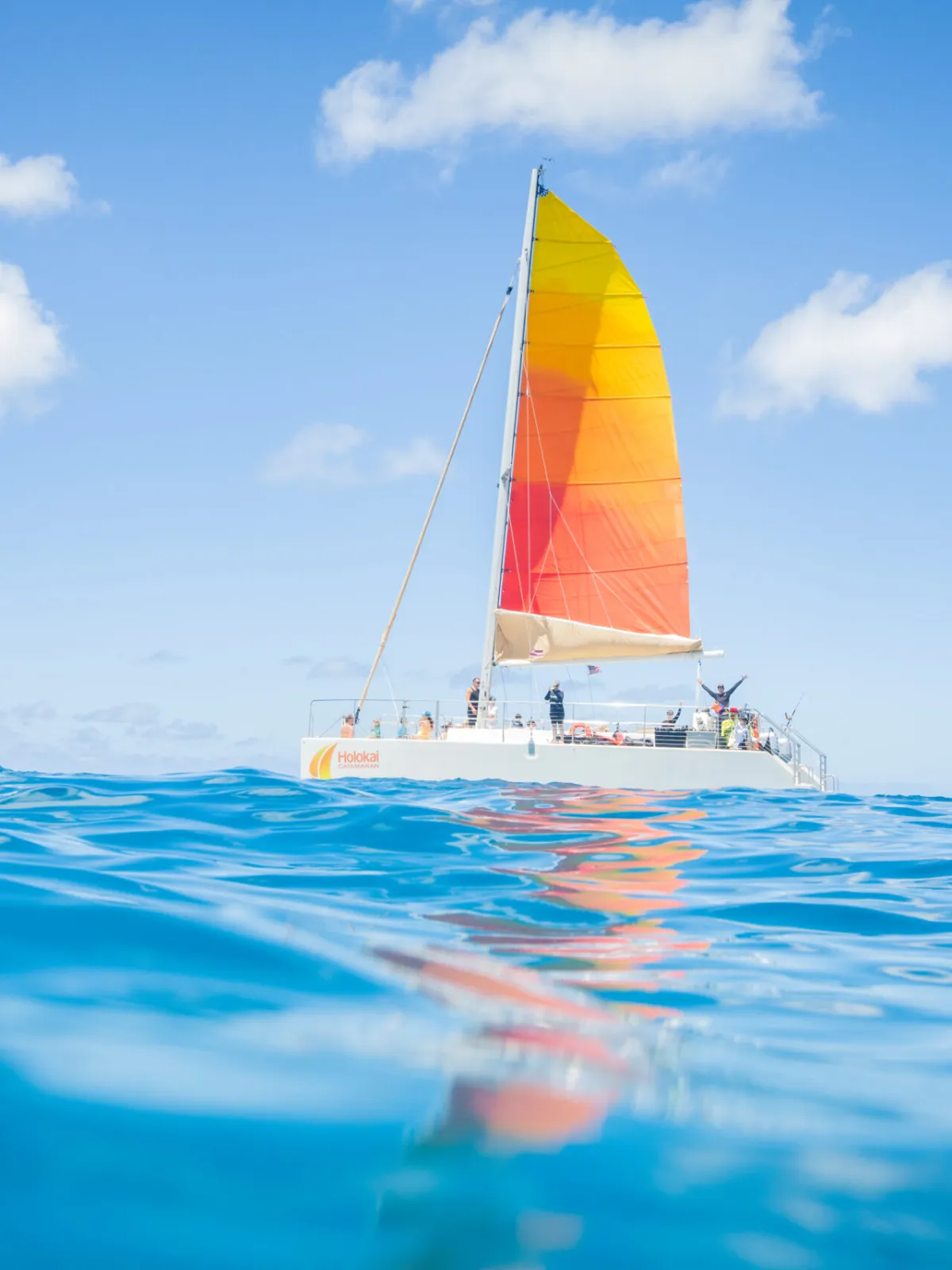 Holokai Catamaran sailing on the waters of Waikiki with Diamond Head in the background